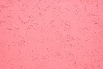 Wall texture with decorative light red plaster. Copy space textured background.