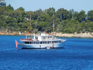 An old luxury yacht off the coast of Vouliagmeni in Attica, Greece