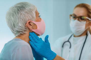 Doctor Examining Senior Woman with Thyroid Gland Problem.