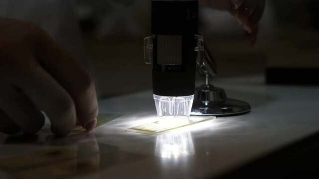 Electron microscope used to conduct grain quality analysis in a dark laboratory  