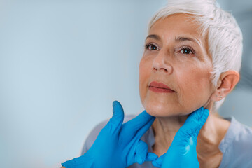 Thyroid Gland Control. Endocrinology Doctor Examining Senior Woman at Clinic. - obrazy, fototapety, plakaty