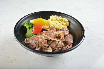 stir fried bbq bulgogi beef rice bowl with scrambled eggs and fried vegetable salad in black bowl in white marble healthy poke bowl menu