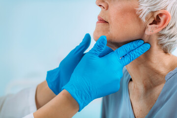 Thyroid Gland Control. Endocrinology Doctor Examining Senior Woman at Clinic. - obrazy, fototapety, plakaty