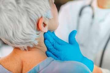 Thyroid Gland Control. Endocrinology Doctor Examining Senior Woman at Clinic.