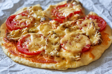 A small size homemade pizza. Delicious pizza baked freshly in the home kitchen
