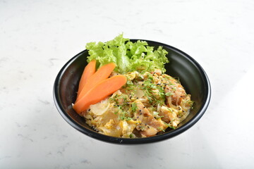 japanese oyakodon chicken rice bowl with salad in black bowl in white marble healthy poke bowl menu