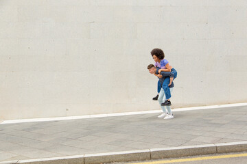 Caucasian man carrying young afro woman on his back