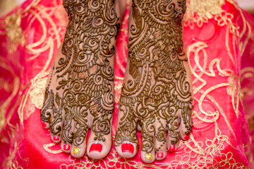 Bride feet painted with Mehndi on her wedding eve.