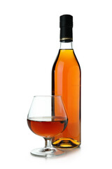 Bottle and glass of cognac isolated on white background