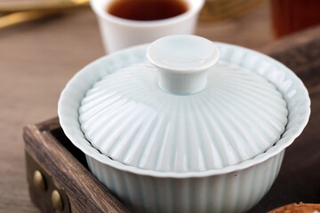 Gaiwan tea close-up in a wooden box plate