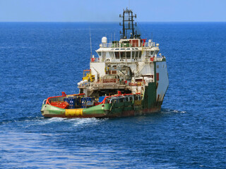Supply boat transfer cargo to oil and gas industry and moving cargo from the boat to the platform. Boat is waiting transfer cargo and crews to platform.