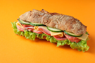 Sandwich of ciabatta bread on orange background