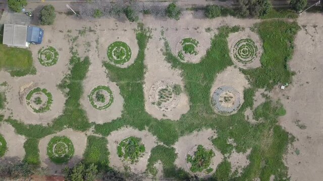 Aerial drone view of a park with a design of round shapes of vegetation and land