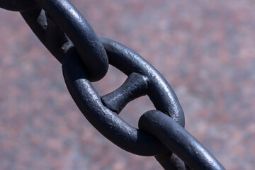 An old rusty chain with peeling paint. Ship chain in the fence on the embankment of St. Petersburg.