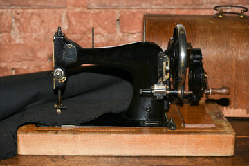 Old sewing machine sews up the fabric