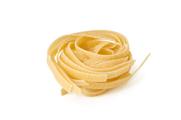 Uncooked nest of tagliatelle pasta isolated on white background