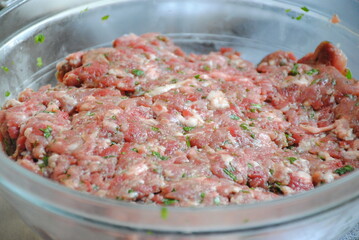 Bowl with minced meat. Process of making home-made dumplings, ravioli or pelmeni. .