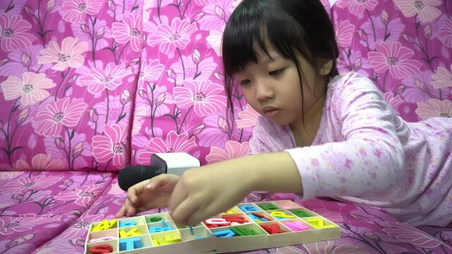 A kid segregate the ABC block in different color.