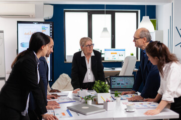 Group of diverse enthusiastic business people, marketing professionals, discussing project ideas. Multiethnic colleagues working planning success financial strategy discussing in office.
