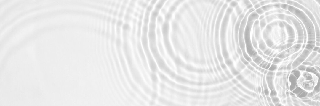 Water panoramic banner background. White water texture, aqua surface with rings and ripples © Irina