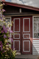 Fototapeta na wymiar Old wooden door with flowers