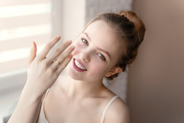 happy young woman showing wedding ring on her finger