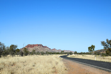 Fototapeta premium Detail image of Simpsons Gap in the MacDonnell Ranges near Alice Springs, Northern Territory, Australia featuring orange rock faces and beautiful ghost gum trees