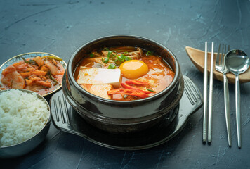 kimchi stew or kimchi soup. Korea’s national dish spicy soup with vegetable, meat, eggs, tofu served in a hot pot. Kimchi Jjigae