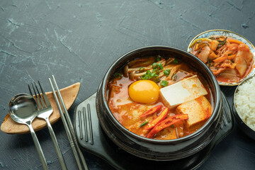 kimchi stew or kimchi soup. Korea’s national dish spicy soup with vegetable, meat, eggs, tofu served in a hot pot. Kimchi Jjigae