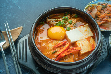kimchi stew or kimchi soup. Korea’s national dish spicy soup with vegetable, meat, eggs, tofu served in a hot pot. Kimchi Jjigae