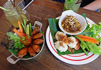 Fried sticky rice served with northern thai curry and chicken wings