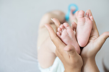 Parent holding in the hands feet of newborn baby