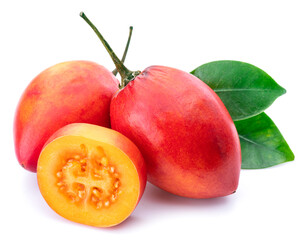 Ripe tamarillo fruits with slices and tamarillo leaves isolated on a white background.