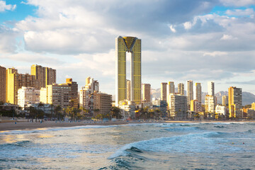 Fototapeta premium sunny sandy beaches of Benidorm with modern housing and mountains on background
