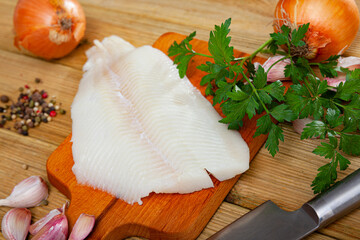 Fresh raw fillet of halibut fish on wooden background