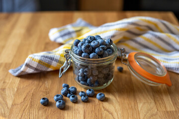 Blueberries in glass jar on a wooden table