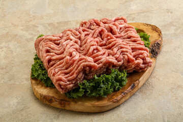 Raw pork minced meat over board