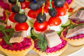 appetizer on the festive table on skewers and in tartlets