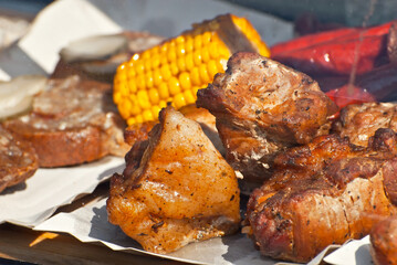 Slice pieces of meat on the grill. barbecue at the festival. Cheese and roasted veal on skewers.