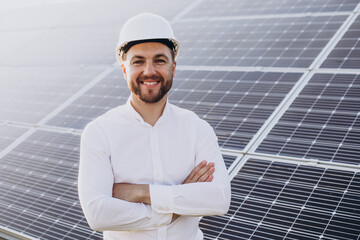Young architect standing by solar panels
