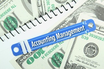 paper fastener, paper money, white paper with the word accounting management