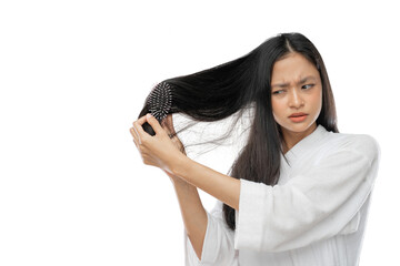a woman wearing a towel using comb with frustration expression against a light gray background