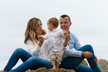 happy family sitting on the beach