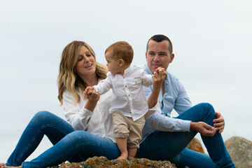 family sitting on the beach
