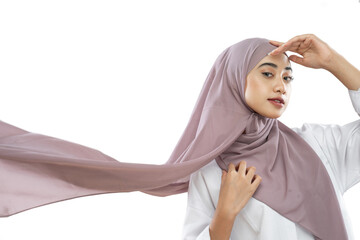 hijab woman wearing purple veil waving in the wind with hand gestures forehead on white background