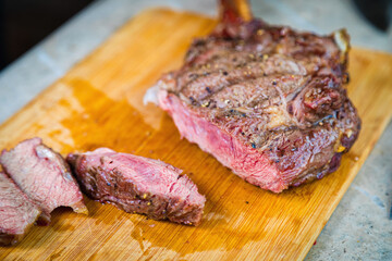Cooked grilled meat on a cutting board. Oven-baked meat for dinner. Close-up