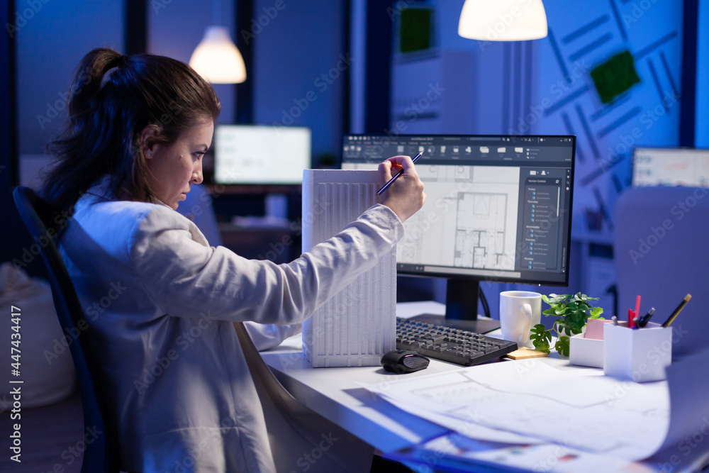 Poster woman architect analysing and matching blueprints for new building project sitting at desk. graphic 