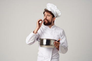 professional chef with a saucepan in his hands trying food cooking work