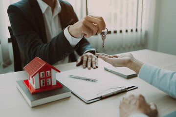 Real estate agent shaking hand with customer about house contract agreement..