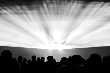 Laser show rays in nightlife party in black and white. Best visual show with a crowd silhouette and great laser rays for e.g. an illustration background of an invitation flyer - 447436462
